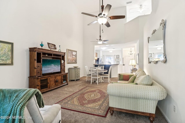 living room featuring carpet flooring, a high ceiling, and ceiling fan