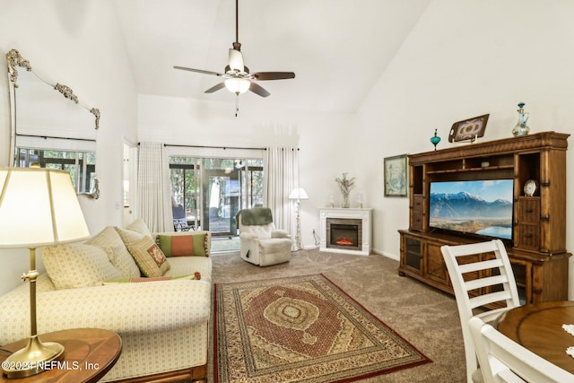 carpeted living room featuring ceiling fan and high vaulted ceiling