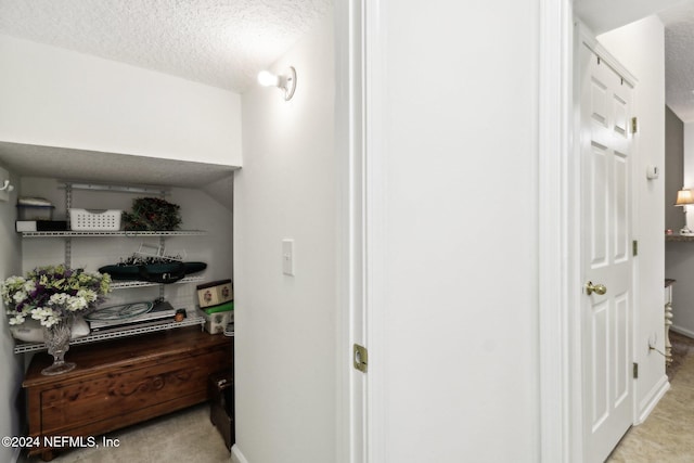 hall with a textured ceiling