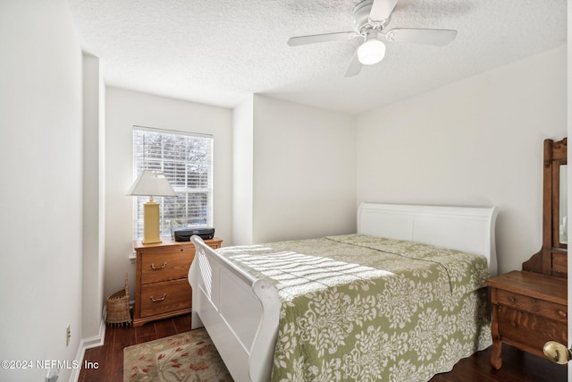 bedroom with ceiling fan, wood-type flooring, and a textured ceiling