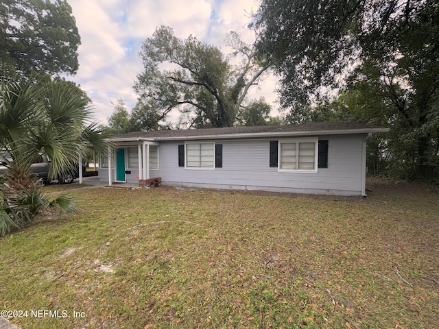 ranch-style home with a yard