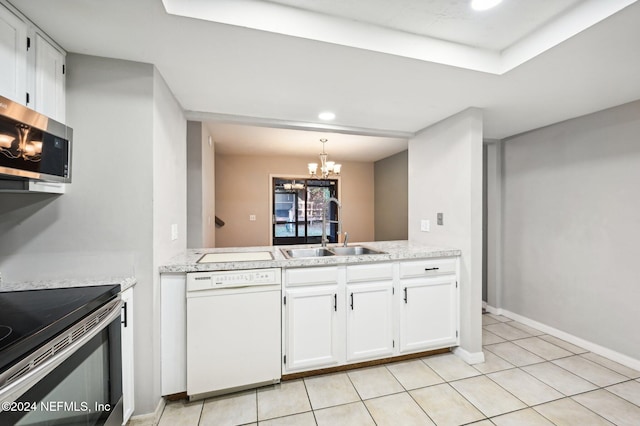 kitchen featuring white cabinetry, sink, stainless steel appliances, an inviting chandelier, and light tile patterned floors