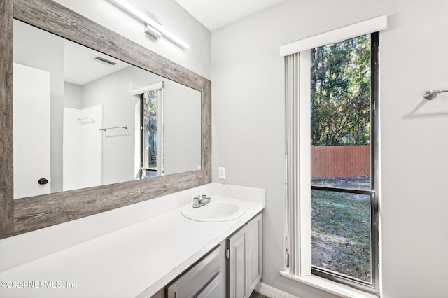 bathroom featuring vanity and a shower