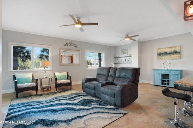 living room featuring ceiling fan, light tile patterned flooring, and ornamental molding