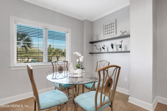 dining area with tile patterned floors and crown molding