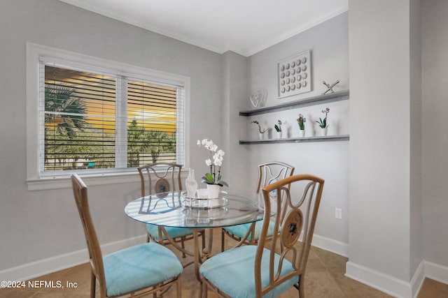 dining area featuring tile patterned flooring and ornamental molding