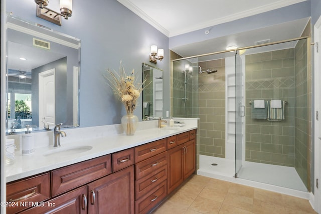 bathroom featuring tile patterned flooring, vanity, a shower with shower door, and ornamental molding