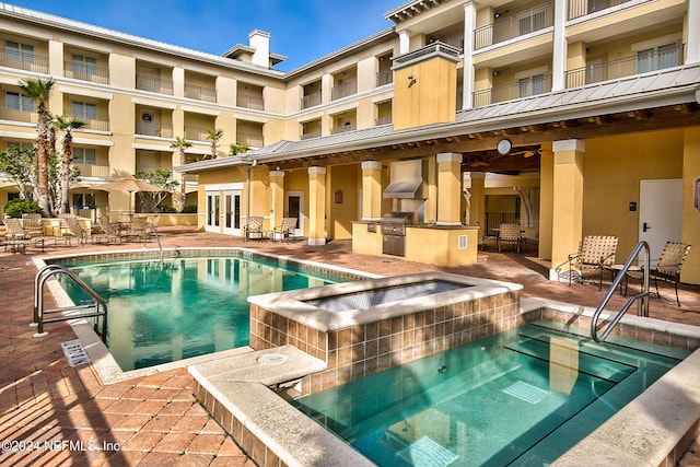 view of pool featuring a patio area, ceiling fan, and a hot tub