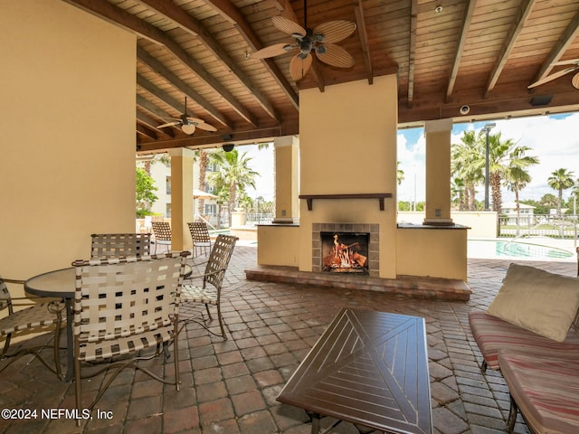 view of patio with a tile fireplace and ceiling fan