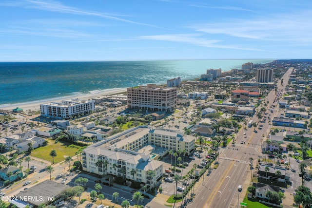 bird's eye view with a water view and a beach view