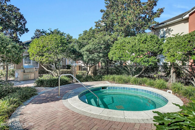 view of pool with an in ground hot tub