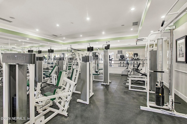 workout area featuring a tray ceiling