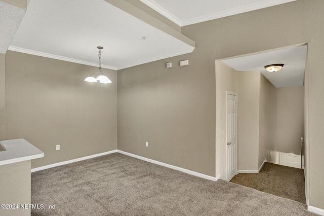 unfurnished dining area with carpet floors, a chandelier, and ornamental molding