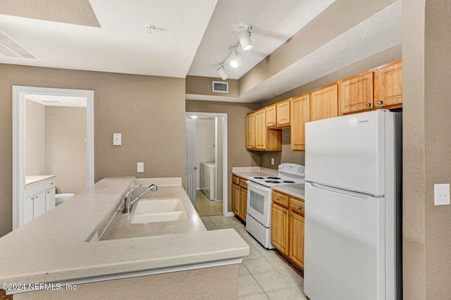 kitchen with white appliances, sink, light tile patterned floors, a textured ceiling, and light brown cabinetry