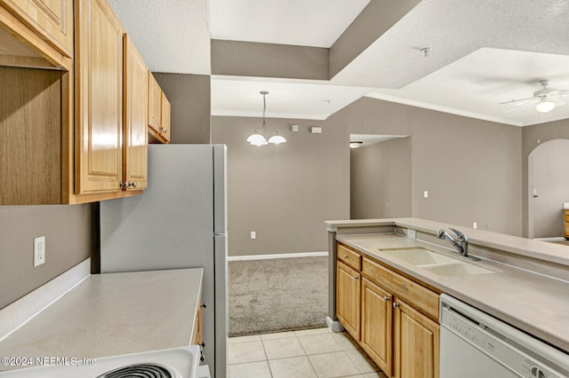 kitchen with sink, hanging light fixtures, white dishwasher, light carpet, and ceiling fan with notable chandelier