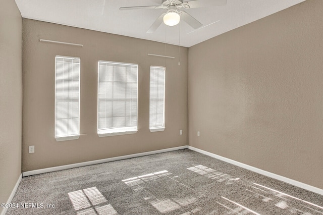 carpeted empty room featuring ceiling fan and a healthy amount of sunlight