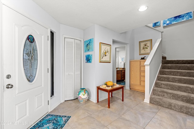 foyer entrance with light tile patterned flooring