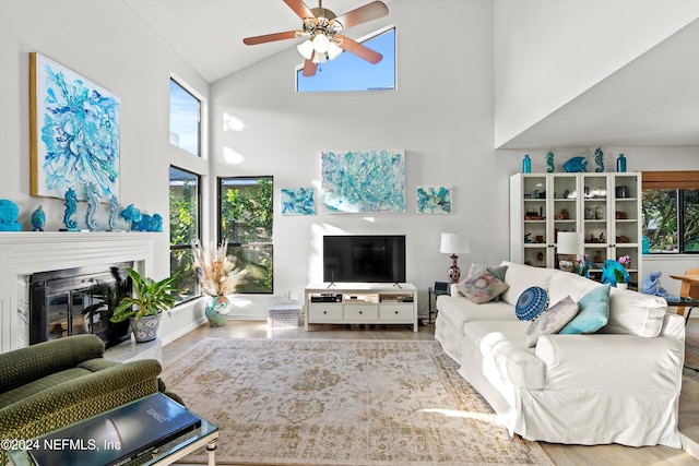 living room featuring ceiling fan and high vaulted ceiling