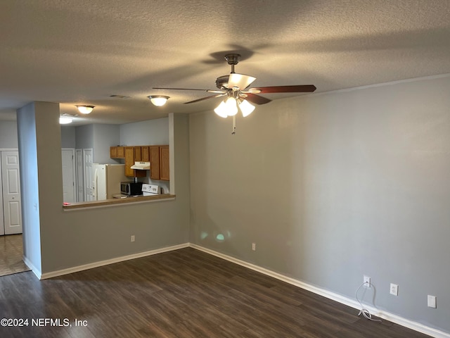 interior space with a textured ceiling, ceiling fan, and dark wood-type flooring