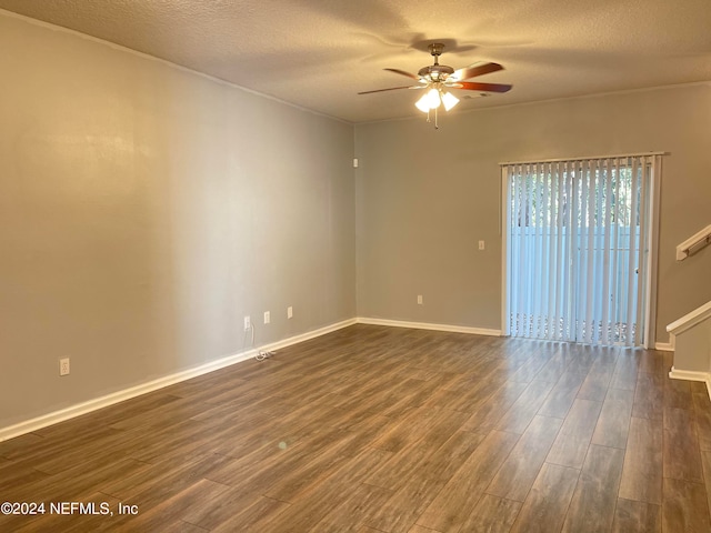 empty room featuring a textured ceiling, dark hardwood / wood-style flooring, and ceiling fan