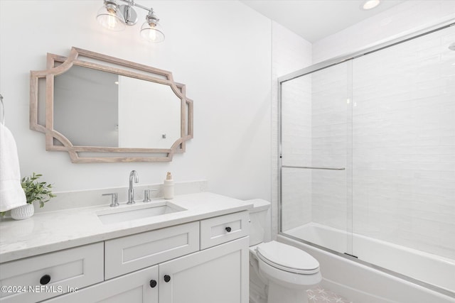 full bathroom with vanity, enclosed tub / shower combo, and toilet