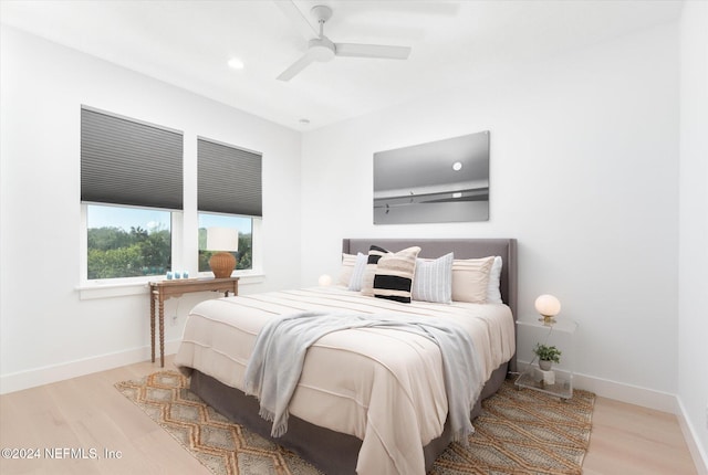 bedroom with ceiling fan and light hardwood / wood-style floors