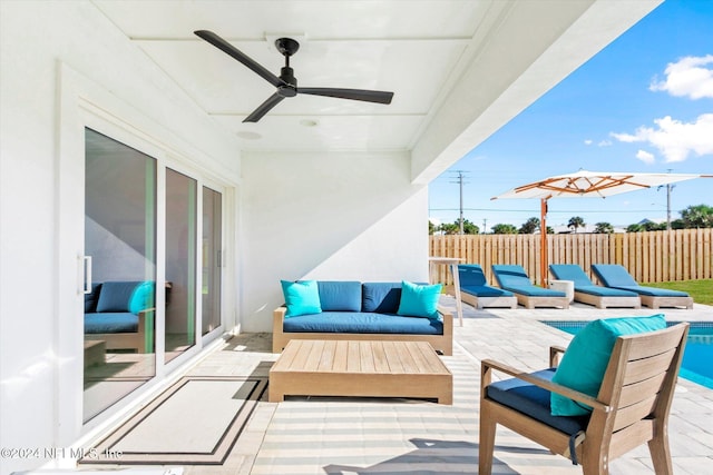 view of patio with ceiling fan, a swimming pool, and an outdoor hangout area