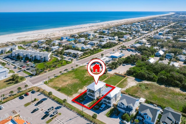 birds eye view of property featuring a view of the beach and a water view