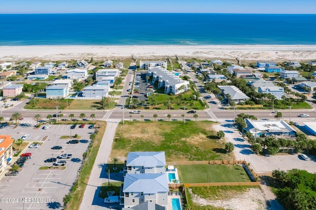 bird's eye view with a water view and a view of the beach