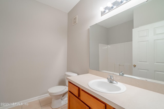 bathroom featuring toilet, vanity, tile patterned floors, and walk in shower