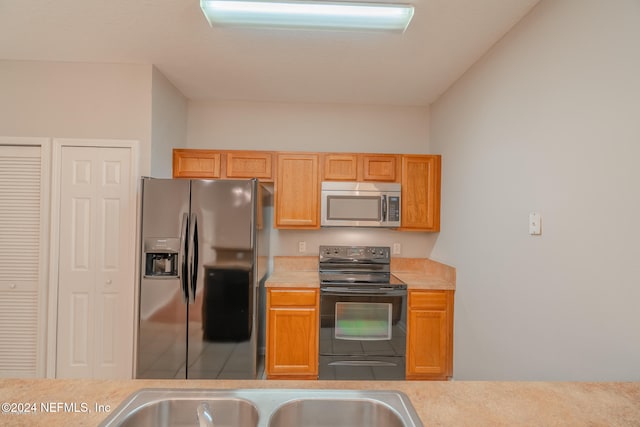 kitchen featuring carpet and stainless steel appliances