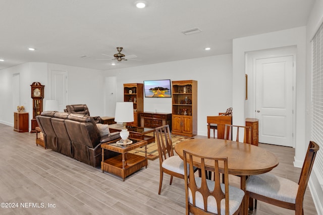 living room with ceiling fan and light hardwood / wood-style flooring