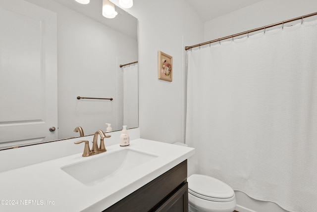 bathroom with a shower with curtain, vanity, and toilet