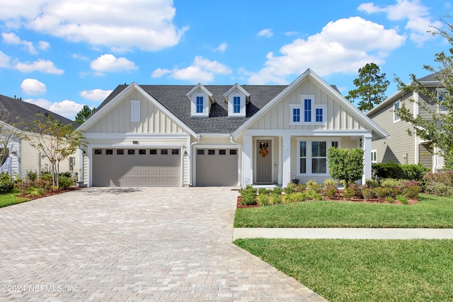 view of front of property featuring a front yard and a garage