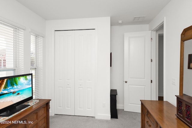 carpeted bedroom with a closet