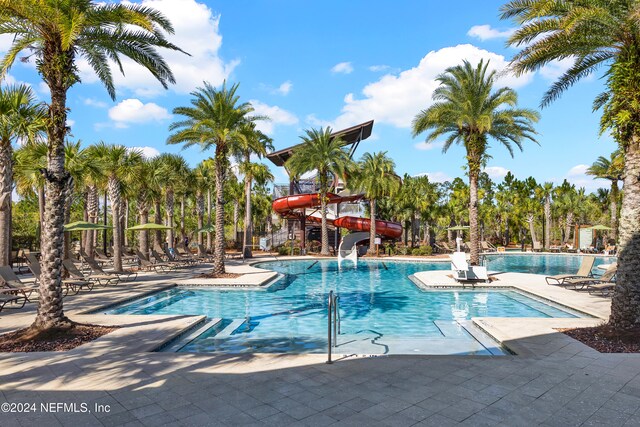 view of pool with a patio area and a water slide