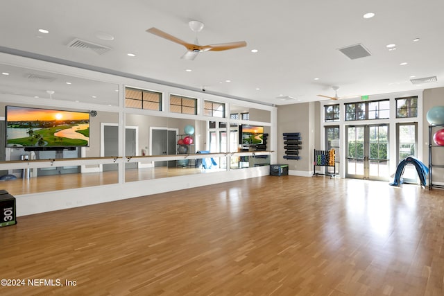 workout area featuring ceiling fan, light hardwood / wood-style floors, and french doors