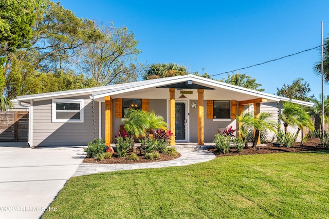 single story home featuring a front lawn and covered porch