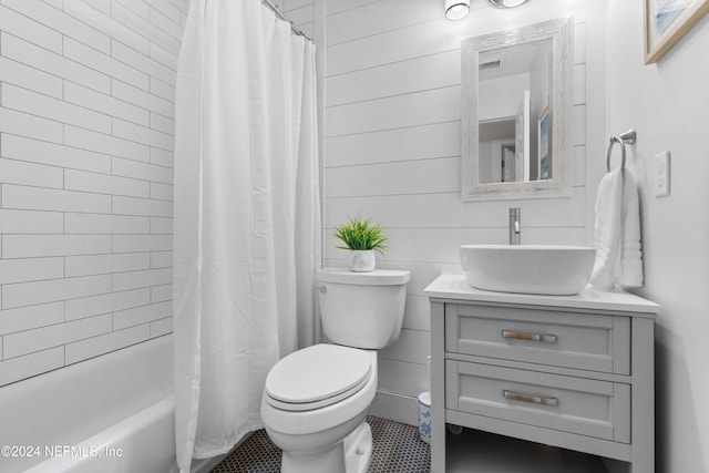 full bathroom featuring tile patterned flooring, vanity, toilet, and shower / tub combo with curtain