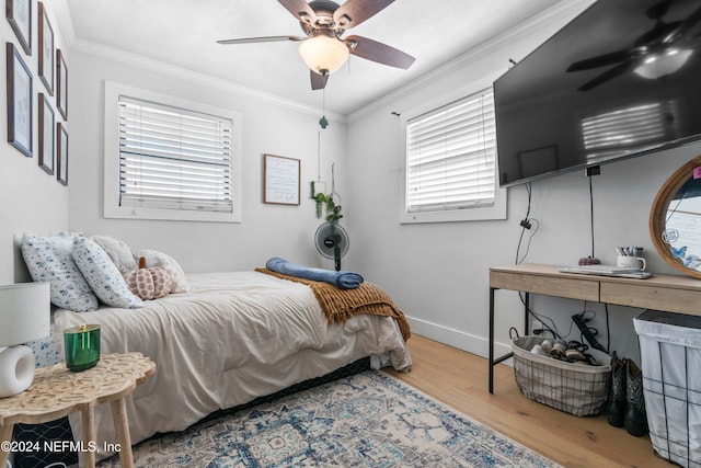 bedroom with hardwood / wood-style floors, ceiling fan, and ornamental molding