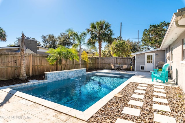 view of swimming pool featuring pool water feature and a patio