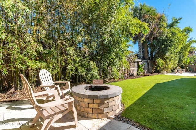 view of yard featuring an outdoor fire pit and a patio area