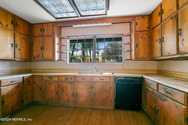 kitchen featuring a textured ceiling, dishwasher, light wood-type flooring, and sink