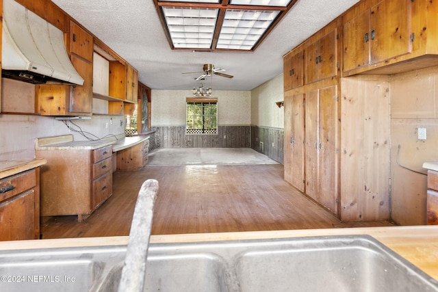 kitchen with ceiling fan, a textured ceiling, and hardwood / wood-style flooring