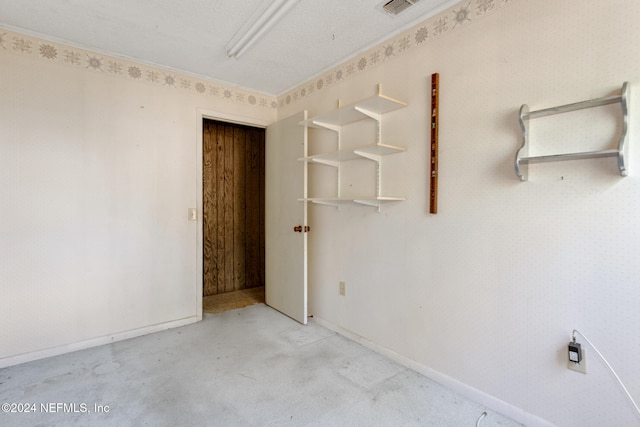 unfurnished room with a textured ceiling