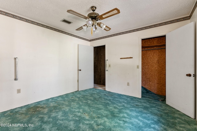 unfurnished bedroom featuring ceiling fan, a closet, a textured ceiling, and dark colored carpet