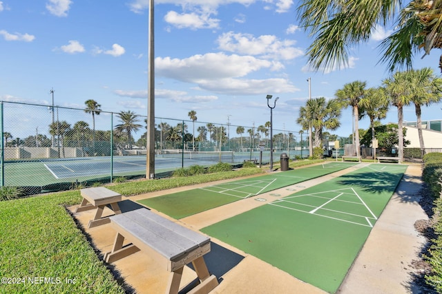 view of home's community with tennis court