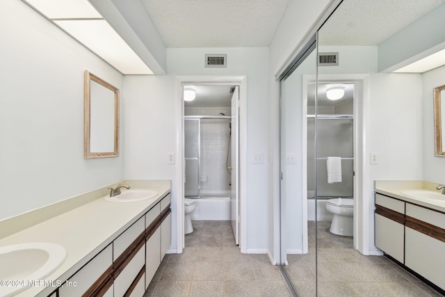 full bathroom featuring vanity, combined bath / shower with glass door, and toilet