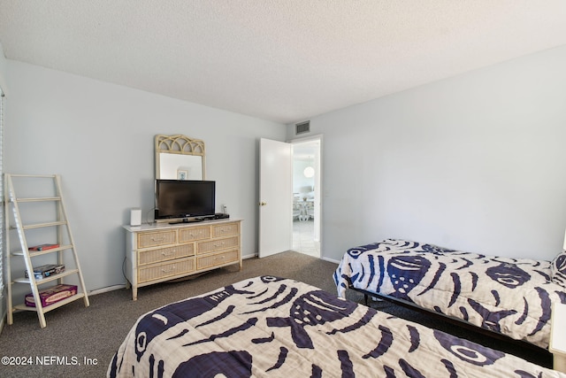 carpeted bedroom with a textured ceiling