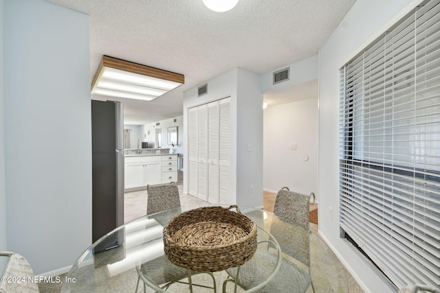 dining area with a textured ceiling